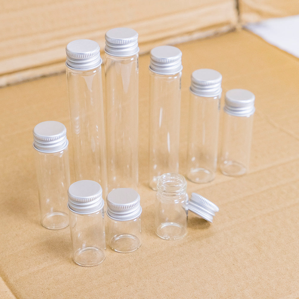 Doorzichtige glazen flessen met zilverkleurige doppen